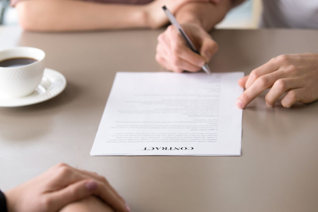 person signing on a contract