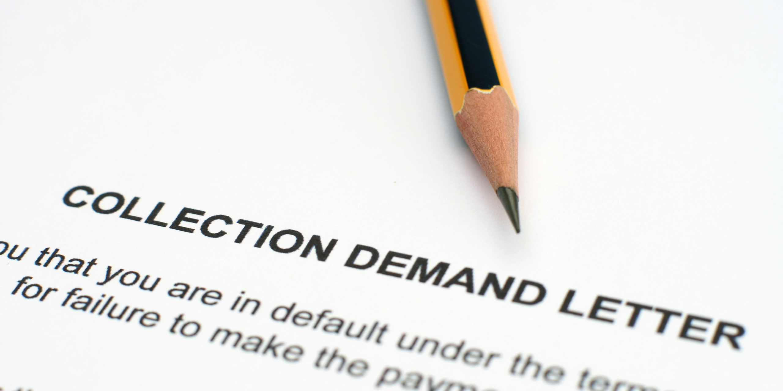 Close-up of a collection demand letter document with a pencil for a construction lawsuit