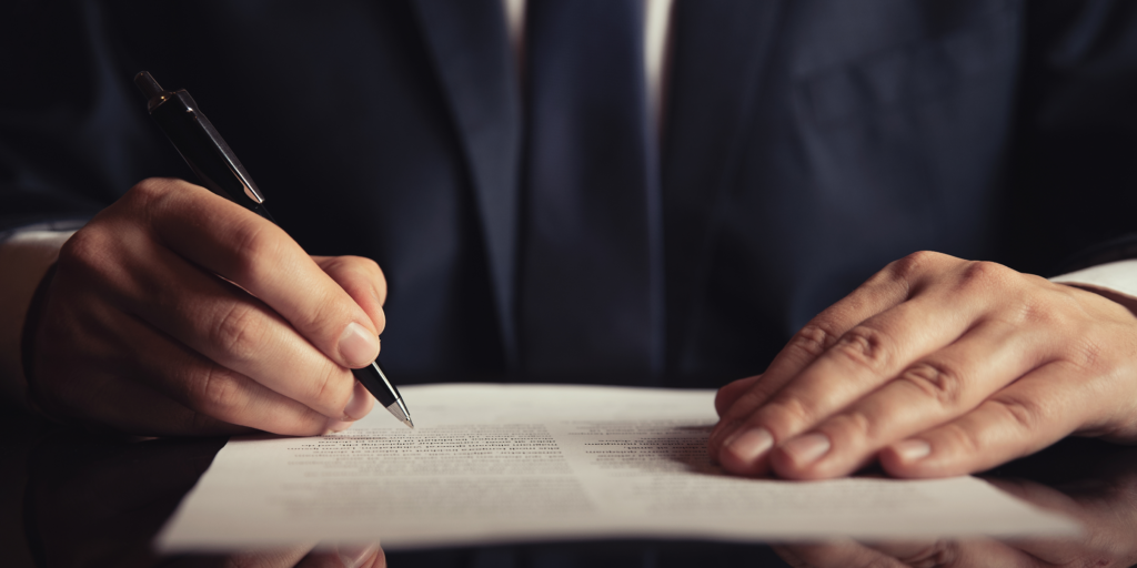 Construction attorney reviewing a breach of contract lawsuit document with a pen